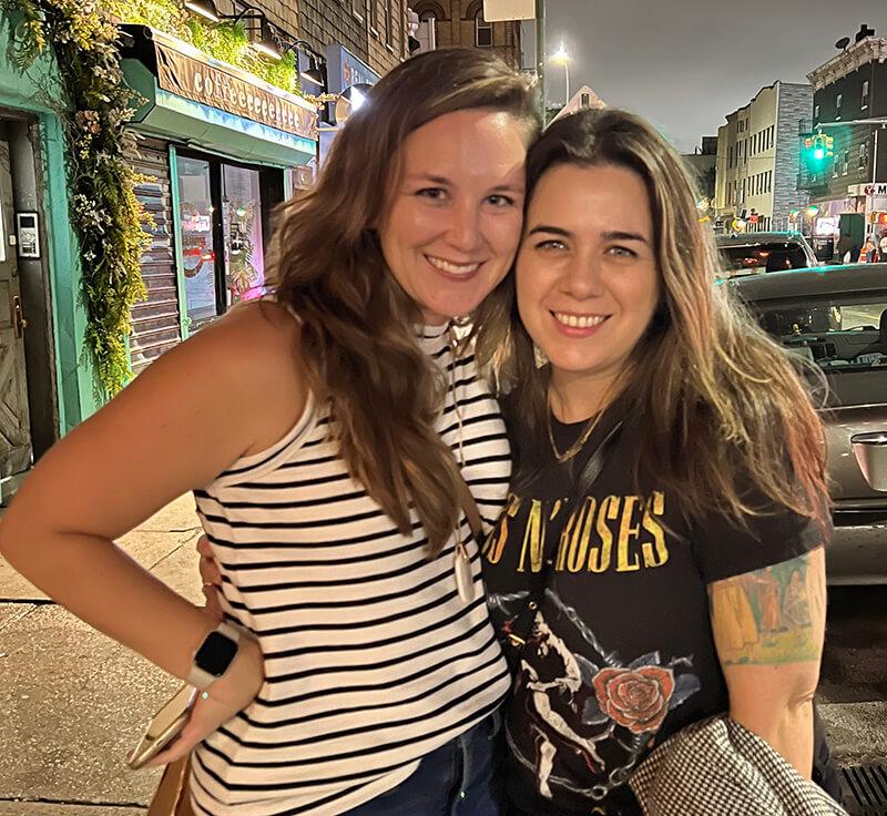 Two women smiling while hugging each other