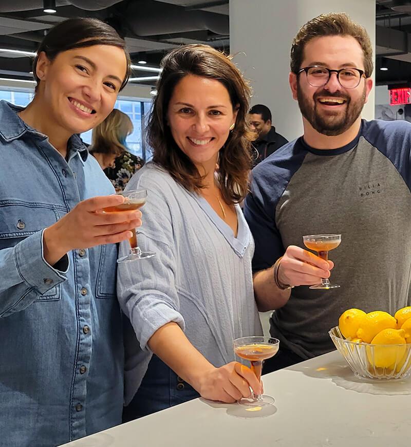 Three people toasting with wine glasses